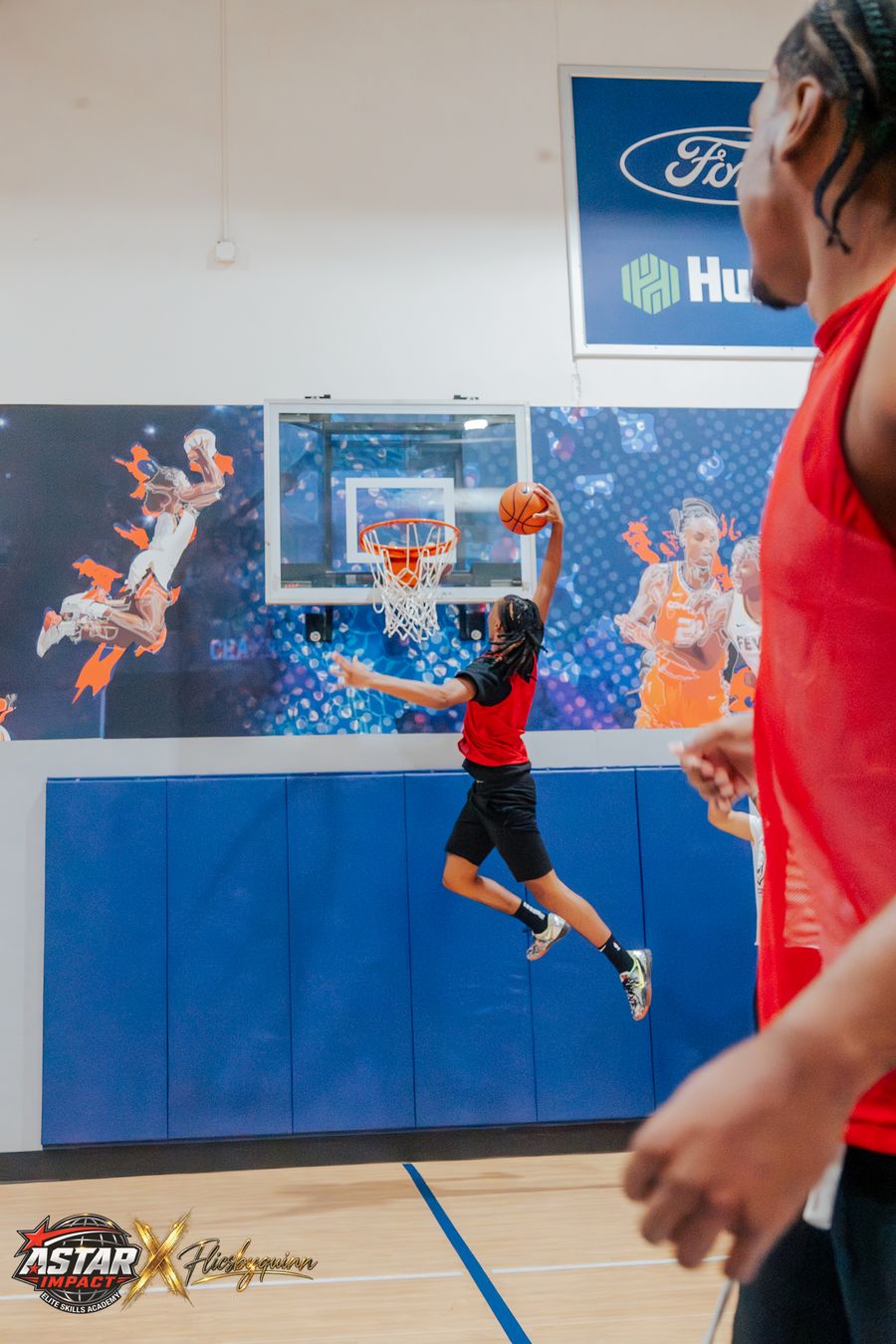 An athlete rising for a layup at camp